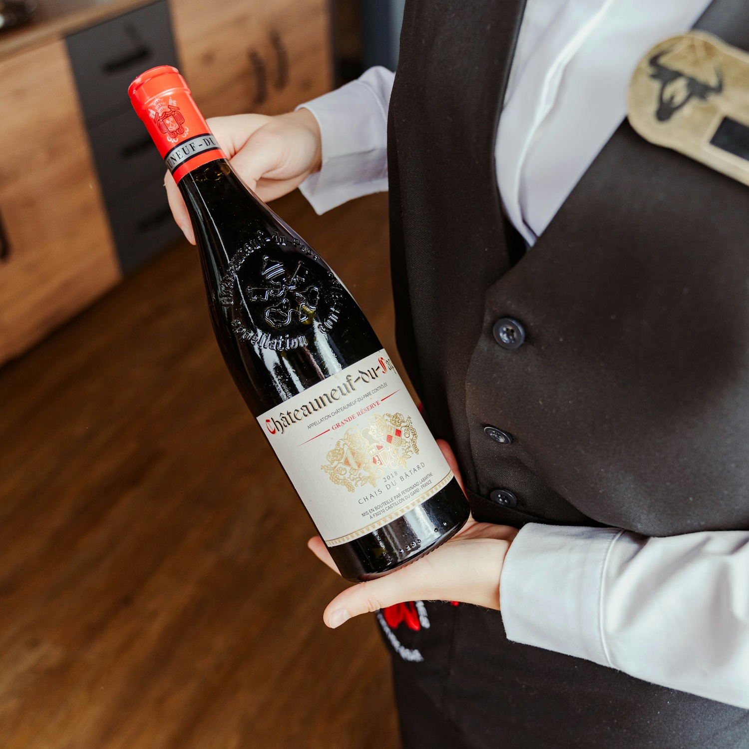 Waiter presenting a bottle of Châteauneuf-du-Pape red wine